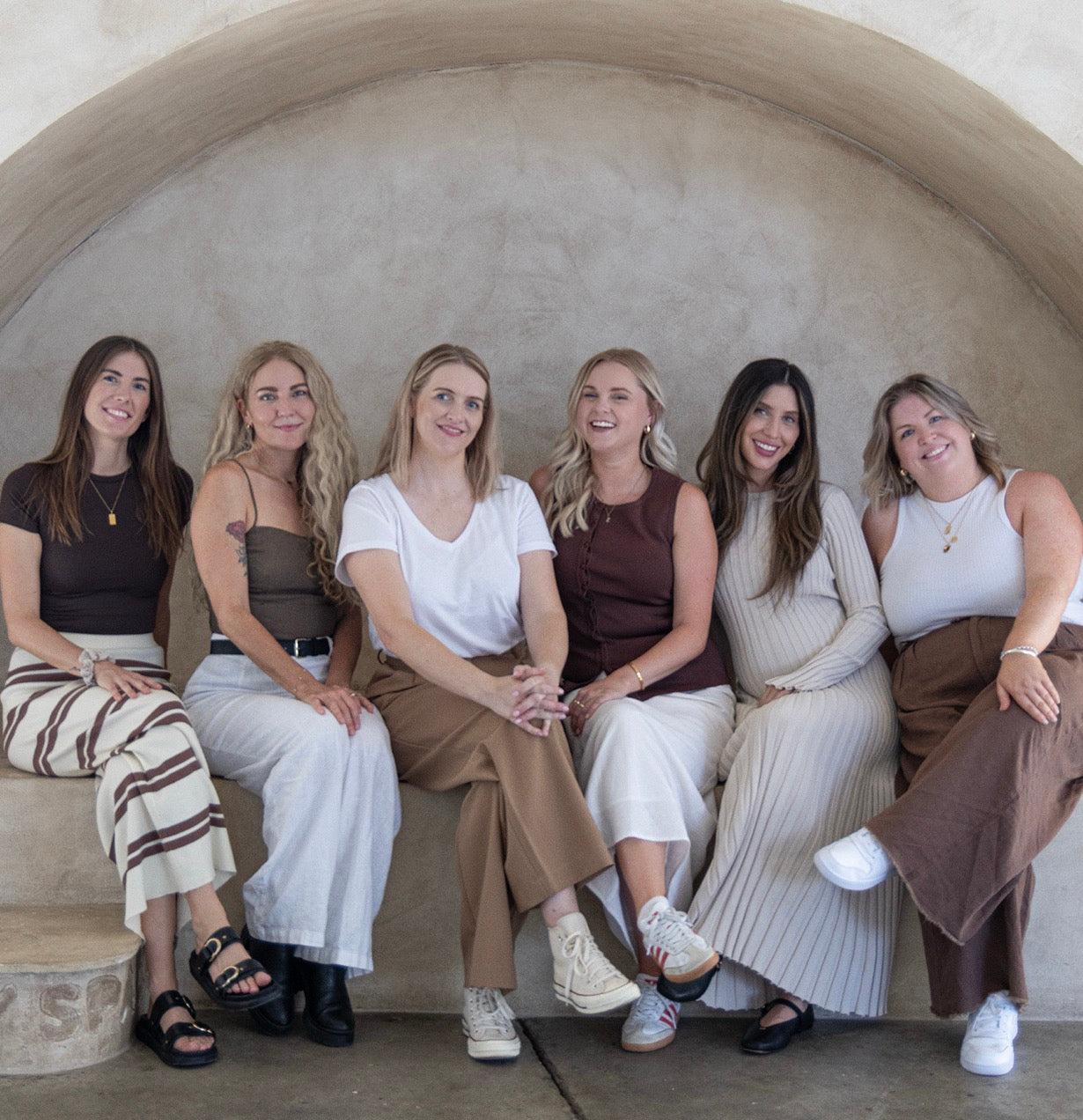 ONEDAY team sitting under an arch