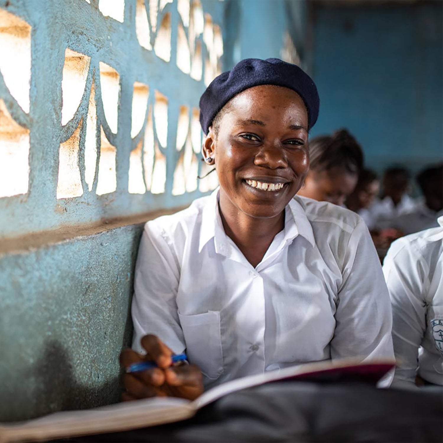 Girl smiling while getting educated thanks to ONEGIRL
