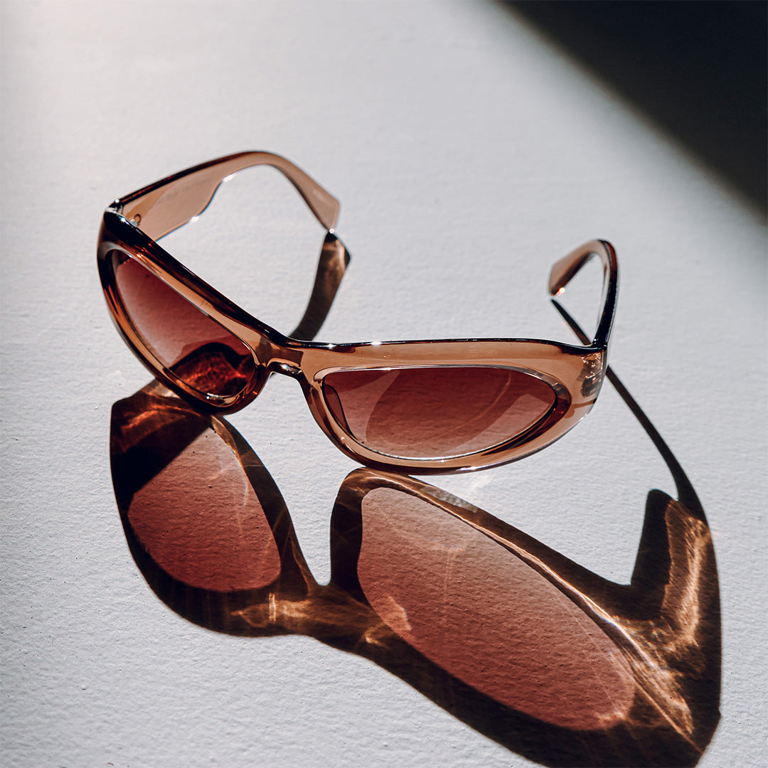 Styler Brown Wrap Around Womens Sunglasses laid out