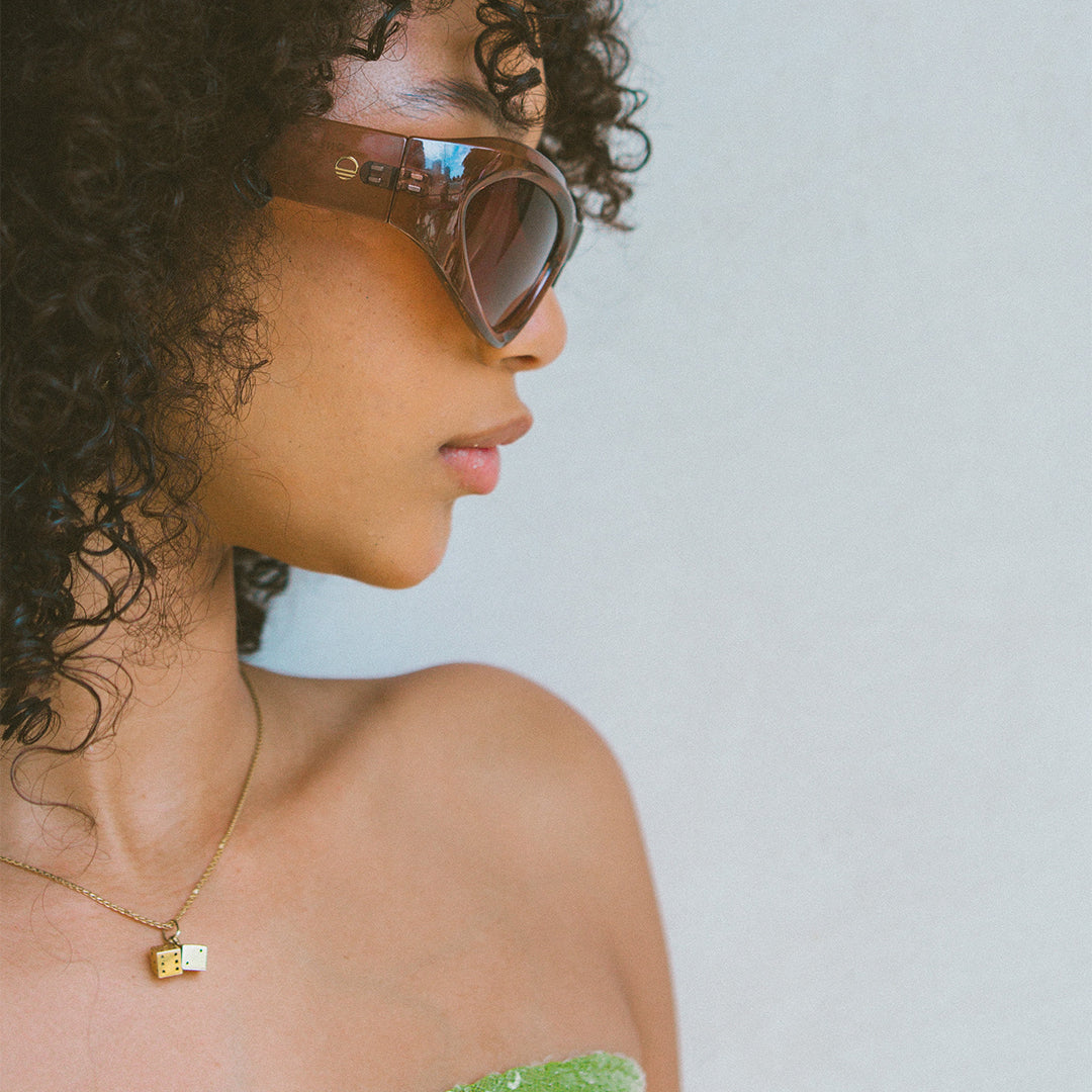 Styler Brown Wrap Around Womens Sunglasses made of polycarbonate and brown lens on female model looking at side on