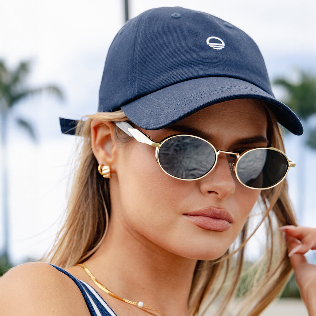 Woman wearing Oneday Got Game Cap in Navy and Brooklyn Sunglasses