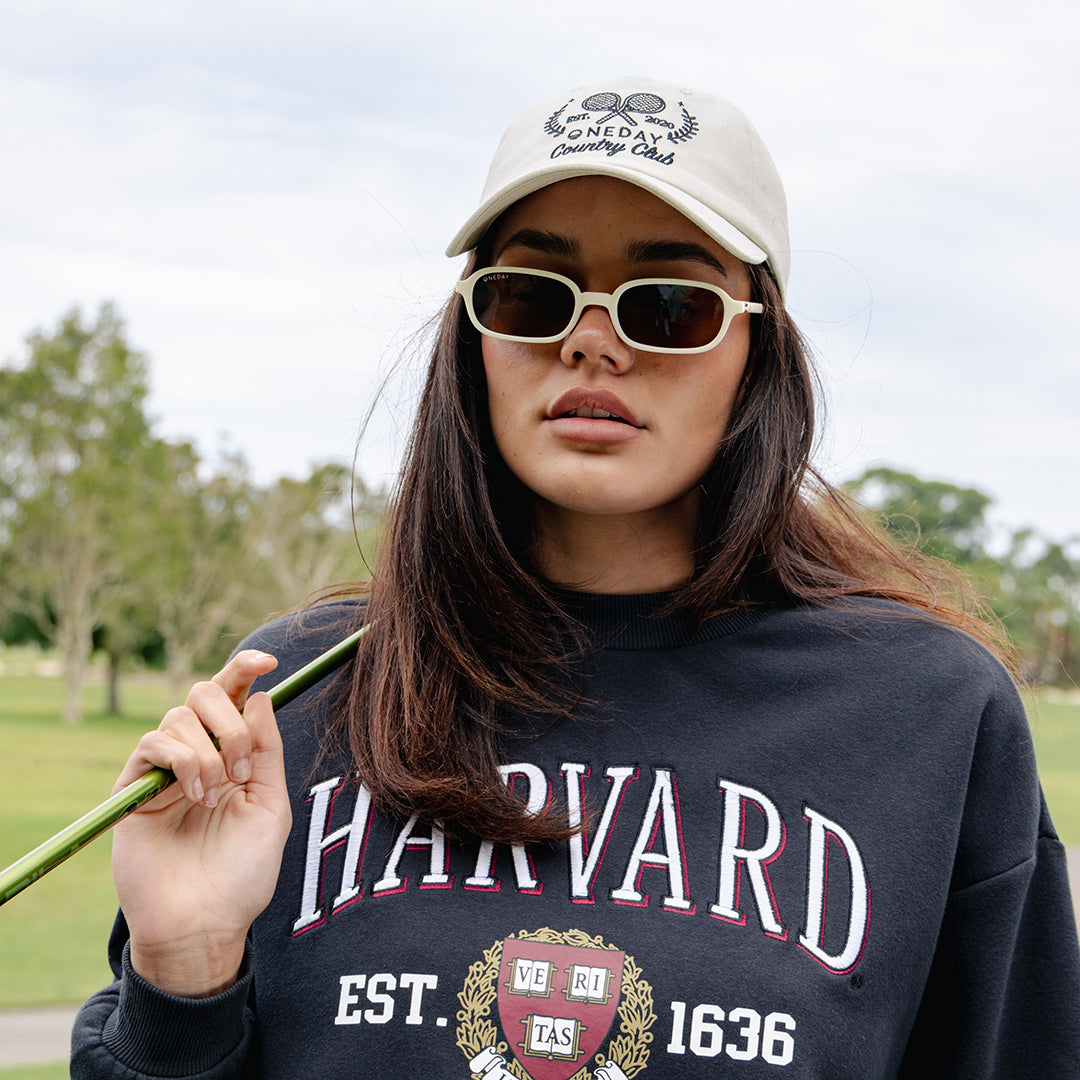 Woman wearing Oneday Serving It Up Cap on golf course