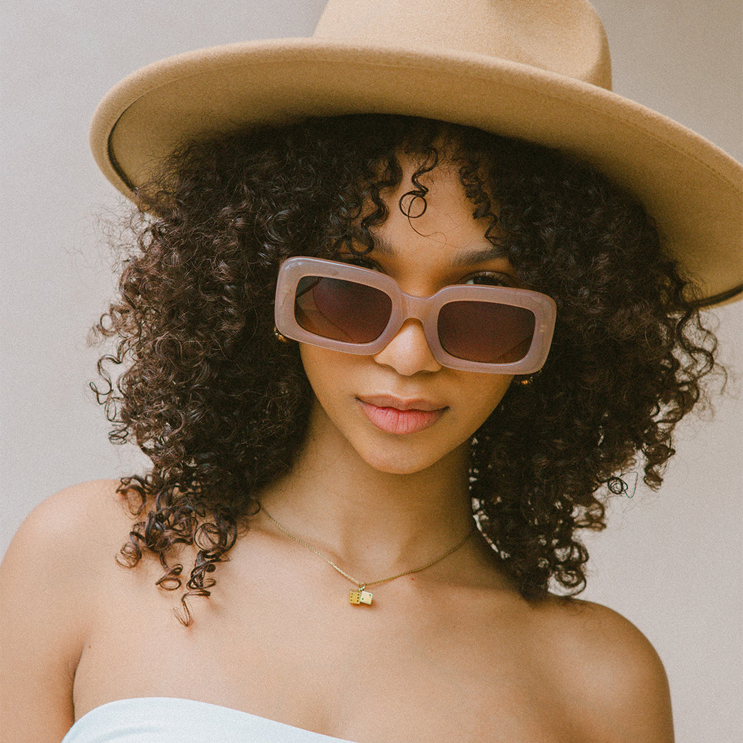 Holiday Brown Rectangle Womens Sunglasses made of polycarbonate and brown lens on model looking towards camera