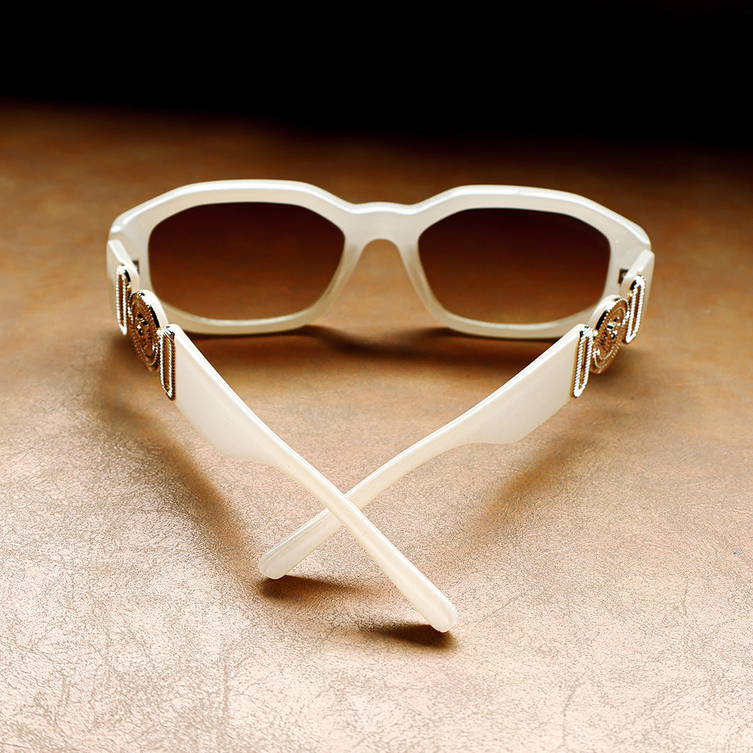 Vogue White Angular Women's Brown Sunglasses laid out on leather couch inside view