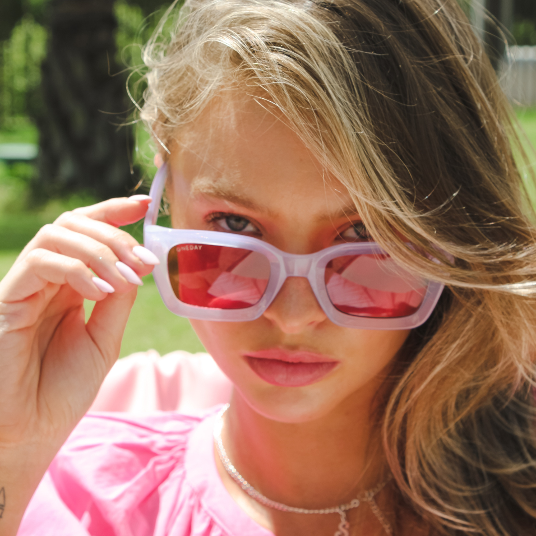 Female model wearing Below Deck - Purple Rose while looking at the camera